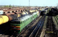 UZ 2TE116-1474 is waiting to depart Poltava Pivdenna (UA) freight yard with a work train besides a UZ 2TE116-1102 powered empty coal train on 27 April 2005.