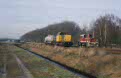 Railion Benelux 6443 + local freight 55810 (Budel - Sittard) and Budelco factory O&K locomotive at the handover yard in Budel (NL), January 2002