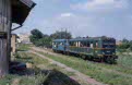 CFR 77 0918 + 77 0956 (from left to right) as passenger train PM 9778 (Lovrin, RO - Jimbolia, RO) leave Grabat Gare (RO) on 13 June 2002